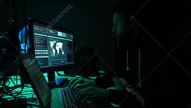 Wanted hackers coding virus ransomware using laptops and computers in the basement. Cyber attack, system breaking and