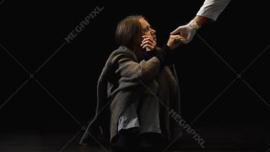 Drug addicted female taking doctors hand in protective glove, hope in future