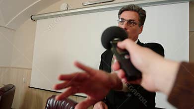 Politician refuses to give an interview to the journalist, no comment. Closes the camera by hand.