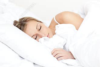 Beautiful young woman sleeping on her bed