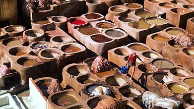 Fes, Morocco, Africa - November 04 2018 : A man hardworking on processing leather inside the Chouara Tannery of Fes, footage video