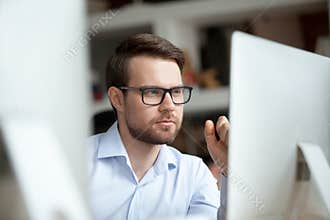 Thoughtful office worker thinking of problem solution looking at computer