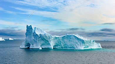 Icebergs in Greenland. Colorful huge Iceberg building with tower and gate.