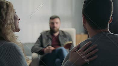 Happy married couple on reception at the psychotherapist