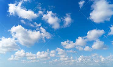 Clear blue sky with white fluffy clouds. Nature background