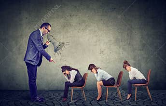 Angry boss screaming in megaphone giving orders to sad looking down female employees