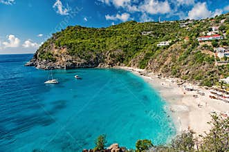 Harbor with sand beach, blue sea and mountain landscape in gustavia, st.barts. Summer vacation on tropical beach