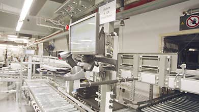Boxes moving on conveyors in a large automated warehouse