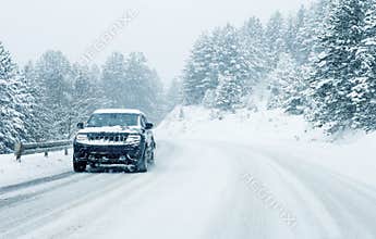 Traffic car on winter road in snow blizzard