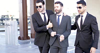 Secret agents arresting a criminal