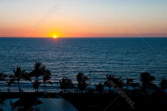 Sunset over tropical shoreline