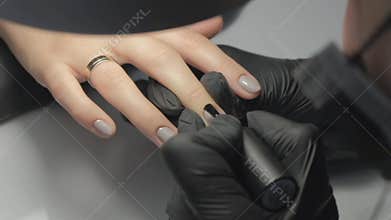 Nail master painting nails close up. Nail salon.