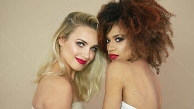 Blonde and curly women in studio