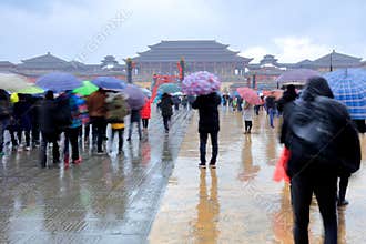 Tourists visit Emperor Qin Palace in hengdian studios in rain, srgb image
