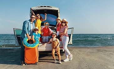 Happy large family  in summer auto journey travel by car on beach