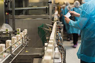 Excursion to the juice factory, packaging and production. a man photographs production.