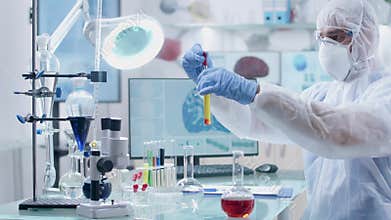 In professional modern high end laboratory scientist is testing some samples of liquid