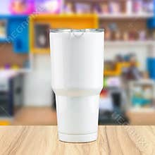 Stainless steel tumbler mug on wooden backdrops. Template of insulated mug for design