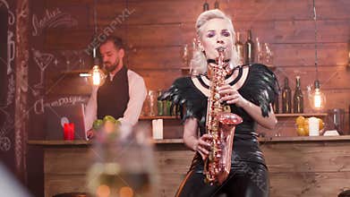 Female saxophonist performing a song in front of an audience