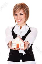 Happy young woman holding small house