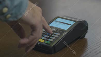 Closeup shot of customer pay over the wireless tradings card-reader. Adult human hands of businessman use bankcard
