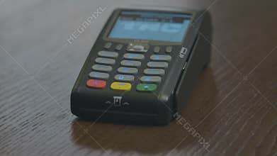 Closeup shot of customer pay over the wireless tradings card-reader. Adult human hands of businessman use bankcard