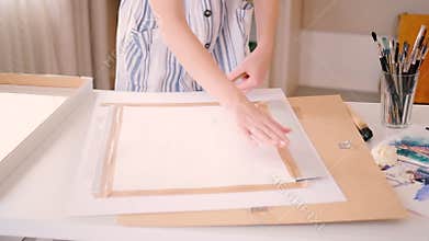 Artist workplace female scotch canvas frame board