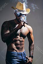 Health. smoking cigarette. exhale smoke. bad habit. confidence charisma. sexy abs of tattoo man. male fashion. muscular