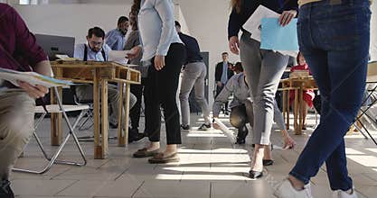 Cooperation and working process. Multiethnic corporate business workers collect sheets of paper from the floor at office