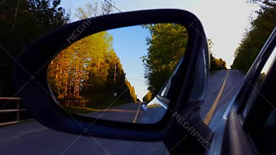 Driving Bumpy Rural Road View of Side Mirror in Daytime.  Driver Point of View POV Looking Down Side View Mirror