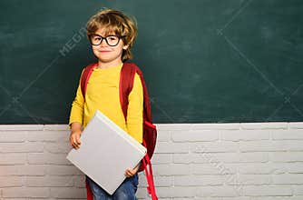 Kids school. Boy from elementary school at the school yard. Happy mood smiling broadly in school.