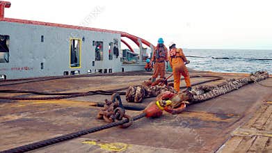 Anchor-handling Tug Supply AHTS vessel crew preparing vessel