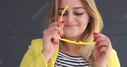 Young woman wearing eyeglasses and blowing a kiss