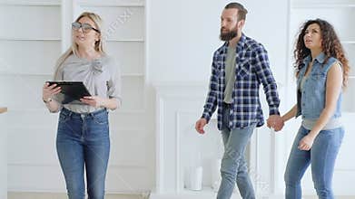 Real estate agent young couple new modern home