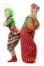 Two smiling clowns are back to back