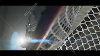 Hockey goalie mask on gate on dark stadium low angle shot