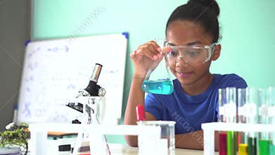 Young African American kid doing chemistry experiment