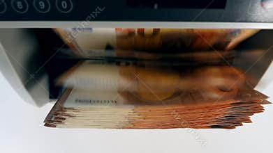 Top view of euro banknotes inside of the counting machine