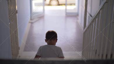 Kid sitting alone on the stairs