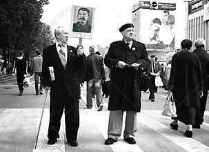 Men at May Day march holding portrait of Stalin