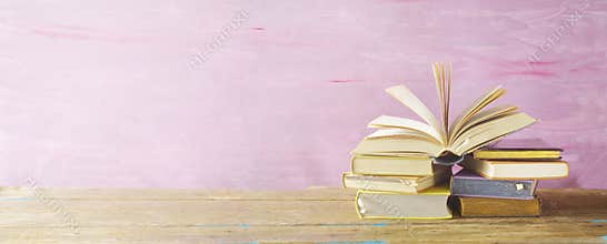 Open book on a stack of books,