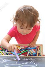 Child draws with chalk