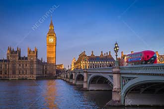 London, England - The iconic Big Ben with Houses of Parliament and traditional red double decker bus
