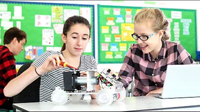 Two Female Pupils Building Robotic Car In Science Lesson