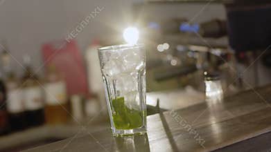 A glass with ce cubes and mint for cocktail.