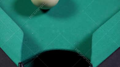 Billiard ball number 3 falling into the hole