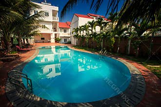 Beautiful Large Oval Pool among Palm Trees