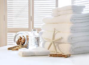 Fluffy white towels on table