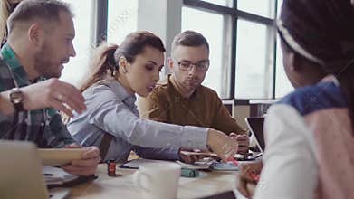 Small architectural company working at project. Creative business meeting of young mixed race team in modern office.