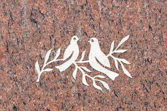 Doves and olive branch on stone surface